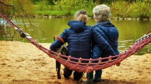 8 Paracord Projects You Must Know 16 2 person watching the lake while sitting on a paracord hammock